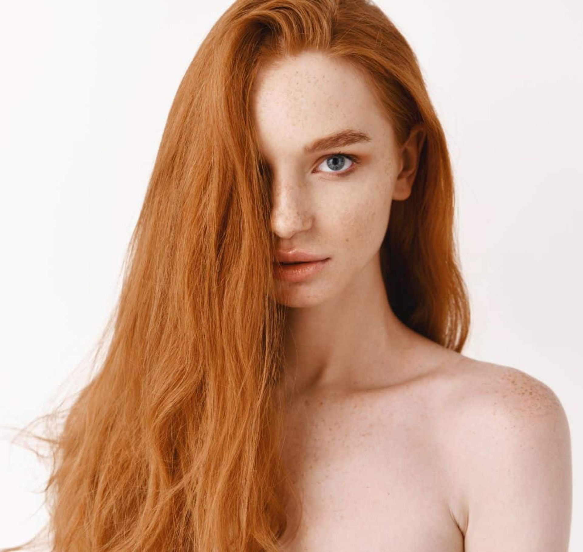 closeup-beautiful-young-woman-with-long-healthy-red-hair-looking-camera-pale-female-redhead-model-gazing-sensual-white-background